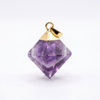 A faceted purple gemstone pendant with a gold metal cap and loop, shown on a clean white background.